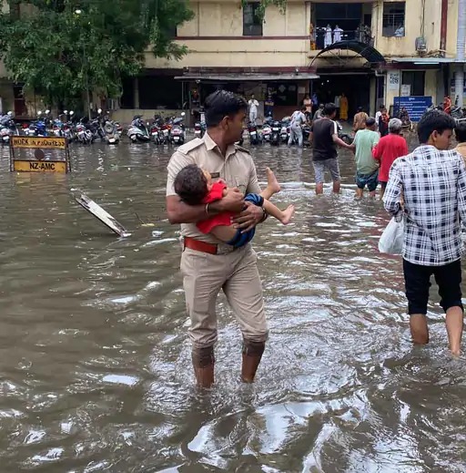 patients-trapped-in-ahmedabad-hospital-khaki-to-help-children-raised-his-hand-and-pulled-out-the-water