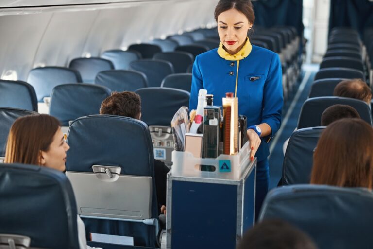 Why do air hostesses sit with their hands under their legs during take off or landing? Know the real reason!